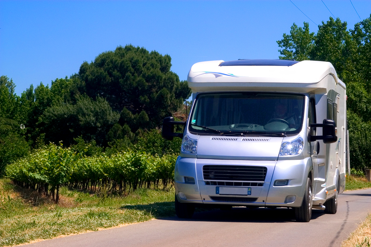 Recreation camper vehicle driving on a rural road in Texas after receiving a RV Home Inspection